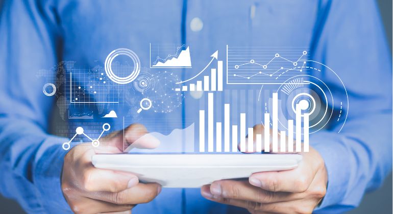 Tablet-based analytics interface with charts and trend lines.